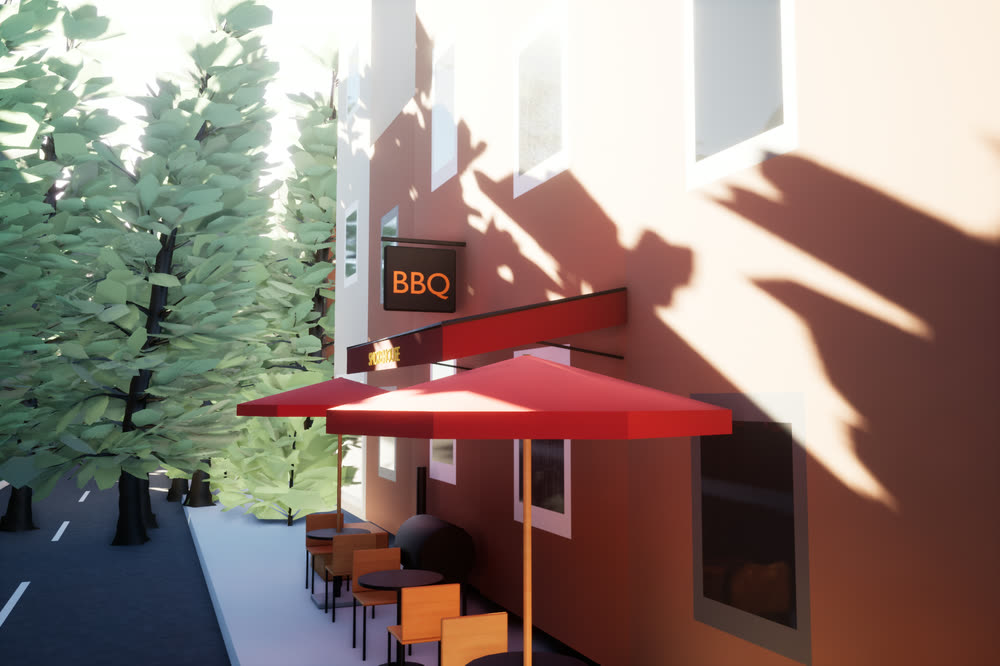 BBQ restaurant on a nearby street, with a red awning over outdoor seating.