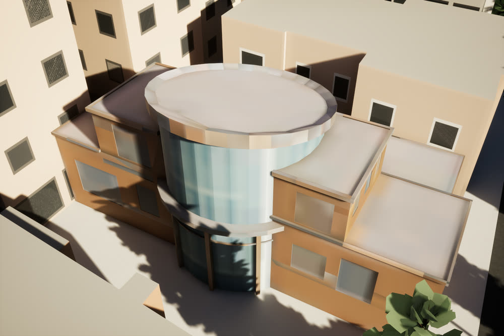 High school building with a round glass entrance, seen from above.