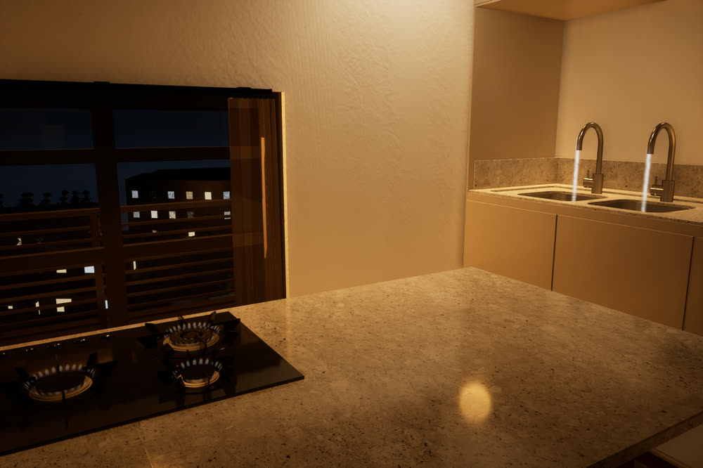 The kitchen at night, with the burners lit and the city lights visible through the window.